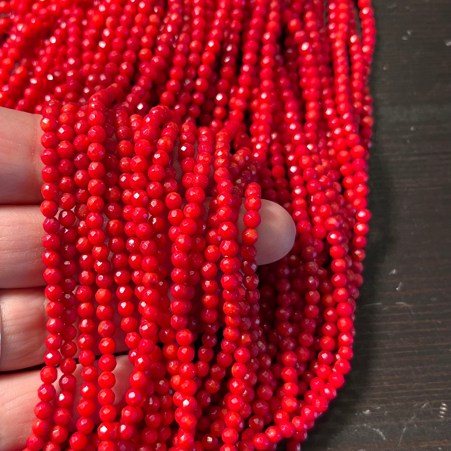 3.5mm Bamboo coral faceted rounds, true red, 16 inches long.